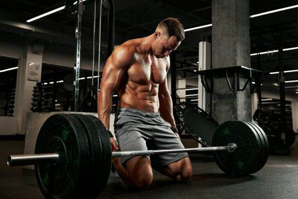 sport, fitness, weightlifting, sports injury and people concept - young woman and personal trainer