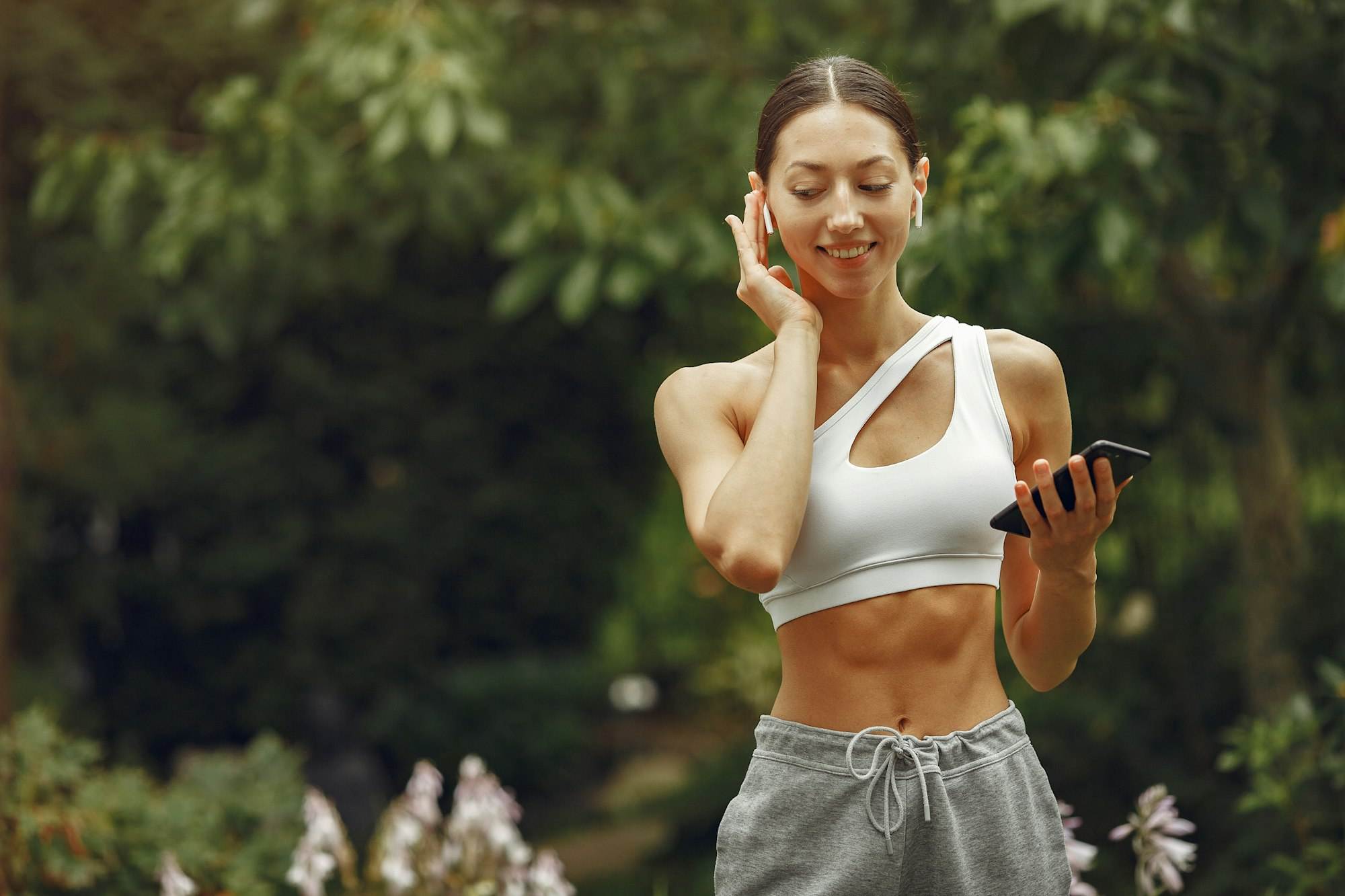 Woman in a sports clothes at the summer park